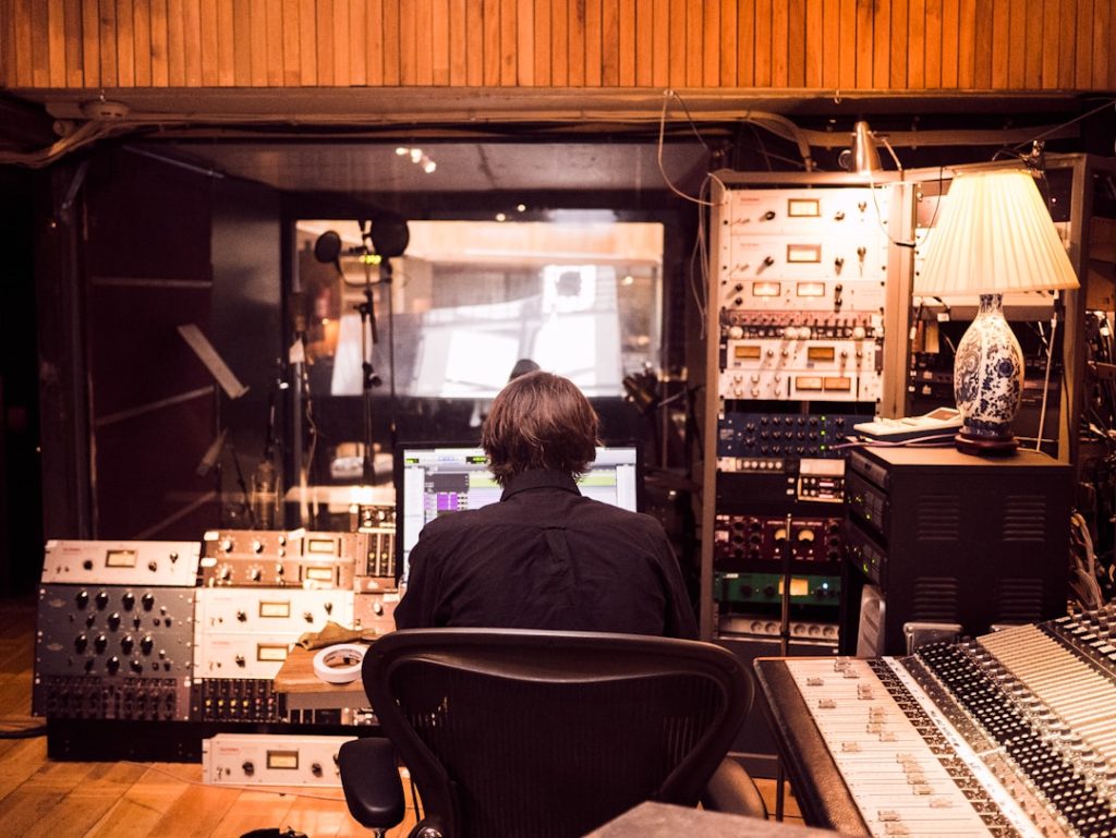 Smart 8 Music Production Mistakes That Kill Clean Releases 1 High-end studio interior set up for music production with monitors, rack gear and golden-hour light